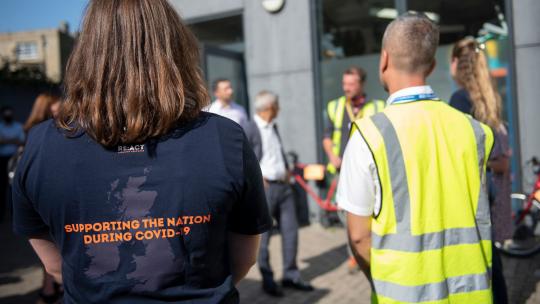 Picture of volunteers at Lewisham Donation Hub from the back and showing vests