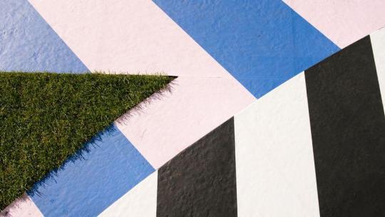 Grass and colourful concreate come together in a zig zag pattern